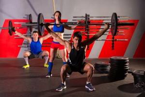 Barbell weight lifting group workout exercise gym.